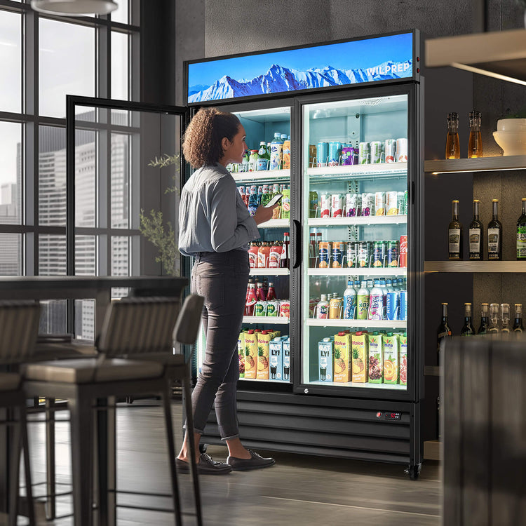 A commercial display refrigerator with two glass doors and multiple shelves filled with various beverages. The refrigerator is black in color and has a digital display at the top.