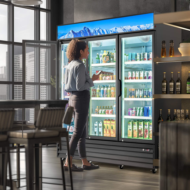 A three-door commercial merchandiser refrigerator with glass doors and multiple shelves visible through the glass, filled with various beverages.