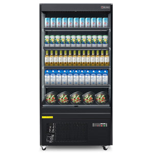 A black vertical air curtain merchandiser with LED-lit shelves displaying bottled beverages and packaged snacks.