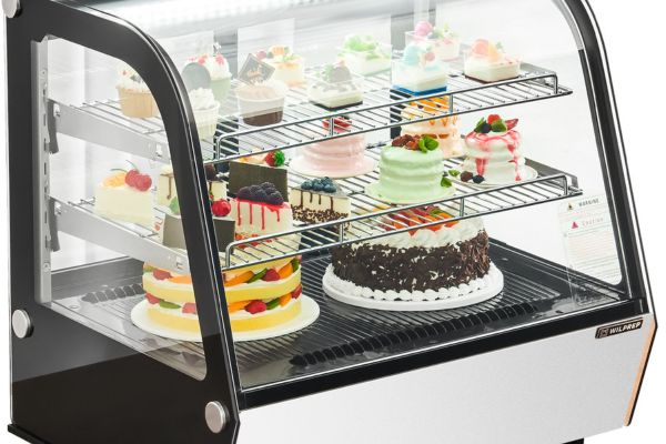 cakes and pastries displayed in a countertop commercial display refrigerator