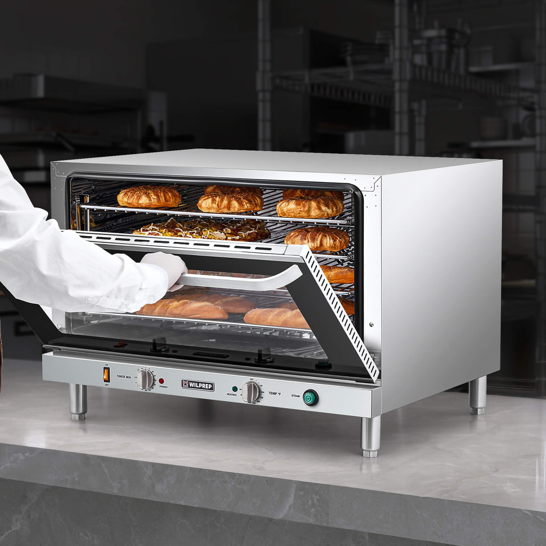 A full size countertop convection oven with visible wire racks inside, and temperature control knobs on the front.