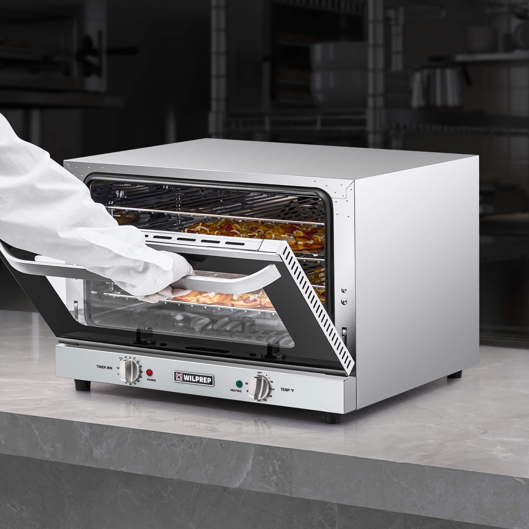 A countertop convection oven with a visible interior rack, temperature control knobs, and a glass door.