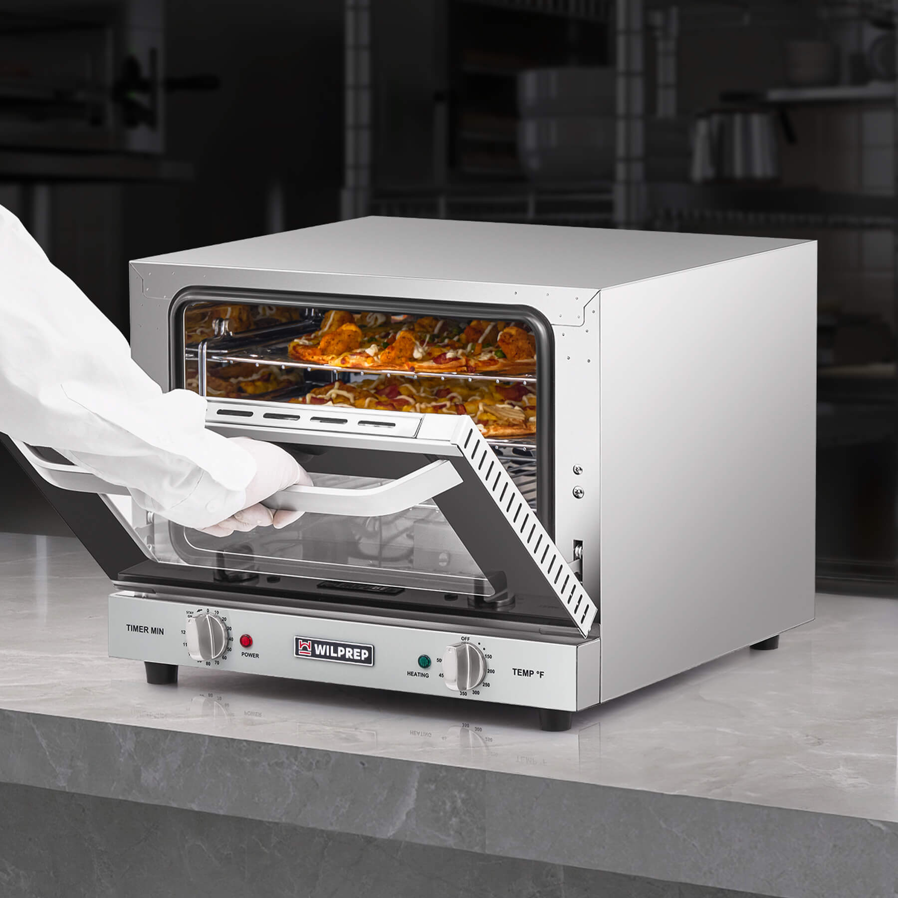 A countertop convection oven with a visible interior rack, temperature control knobs, and a glass door.