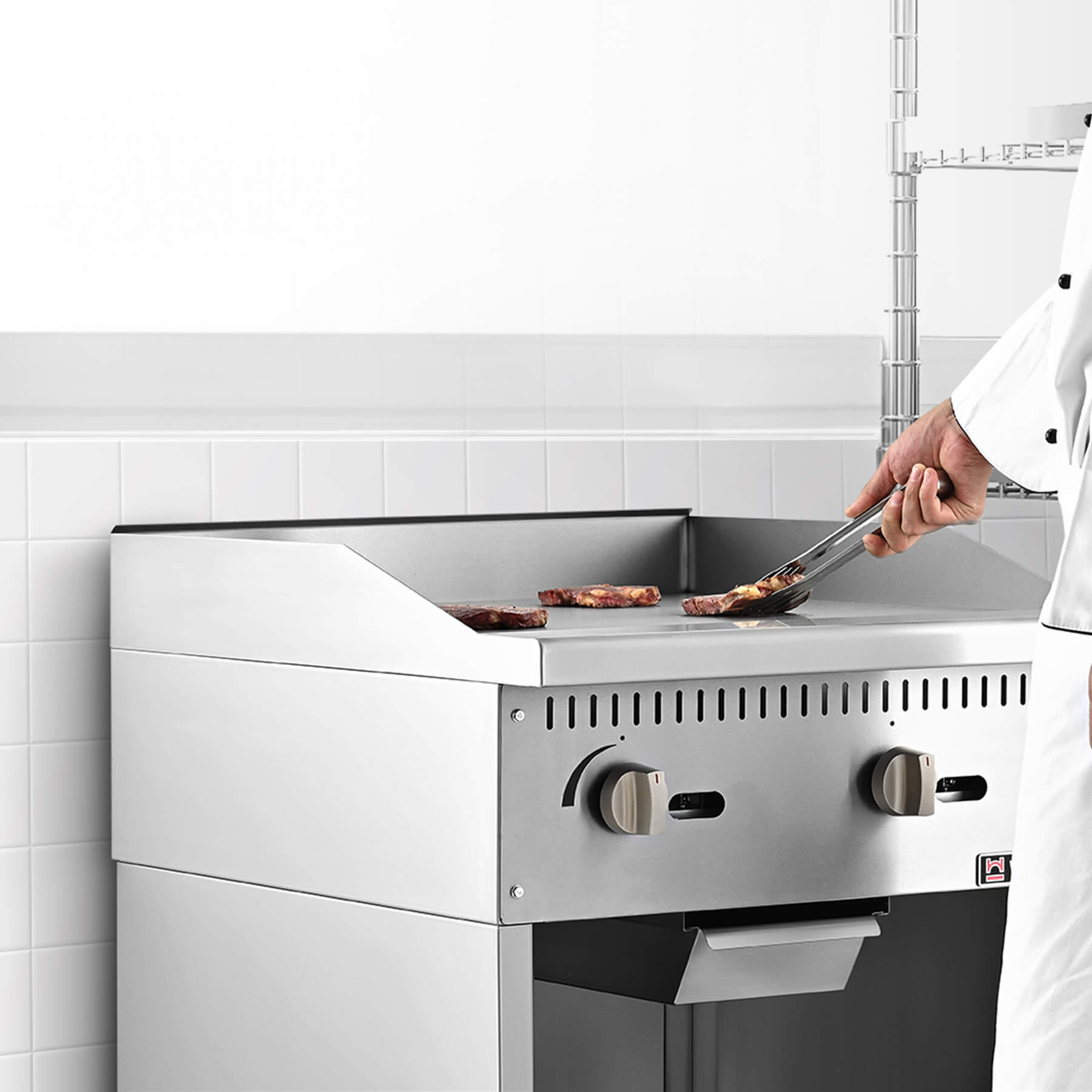 A 24-inch commercial gas griddle with two burners, a cabinet base, and knobs for control, made of stainless steel.