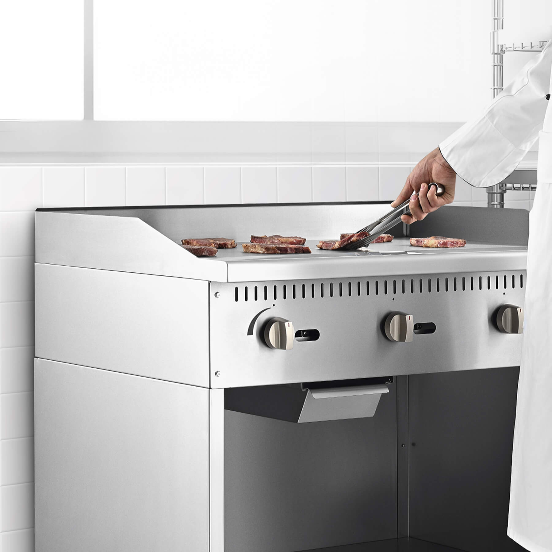 A 36 inch commercial gas griddle with cabinet base, featuring multiple knobs for control and a stainless steel finish.